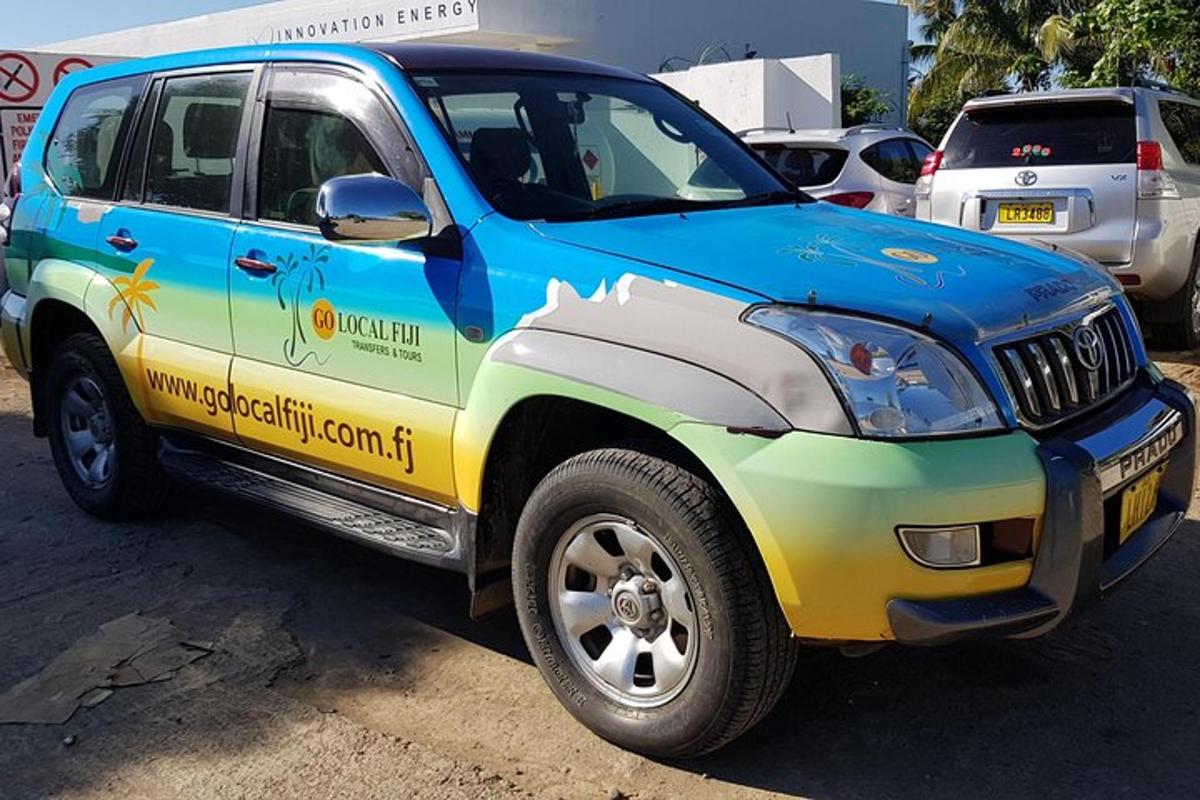 a blue and yellow truck parked in a parking lot