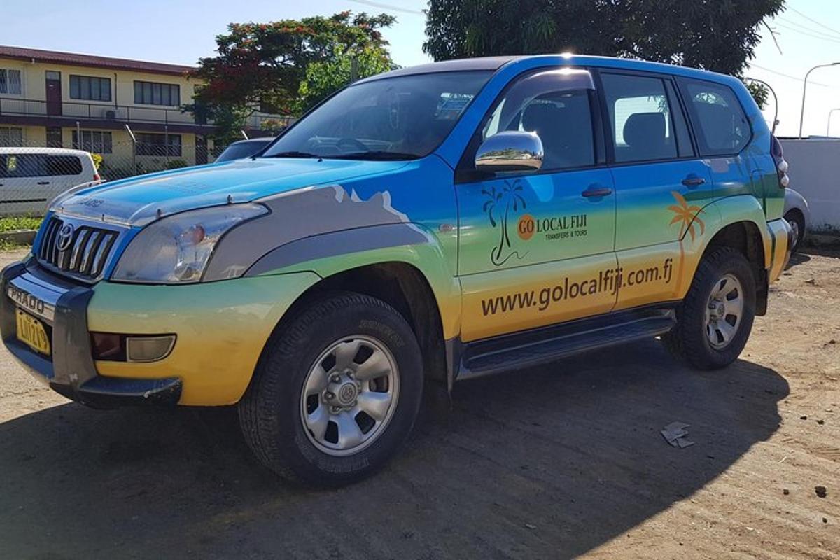 a blue and yellow truck parked in a parking lot