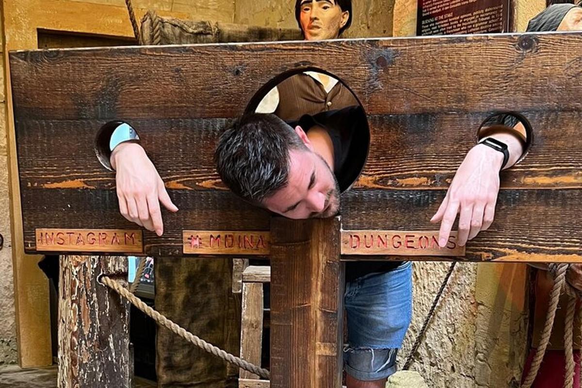 a man laying his head on a wooden bench