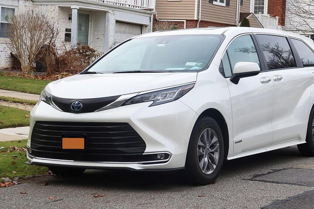 a white toyota van parked in a driveway