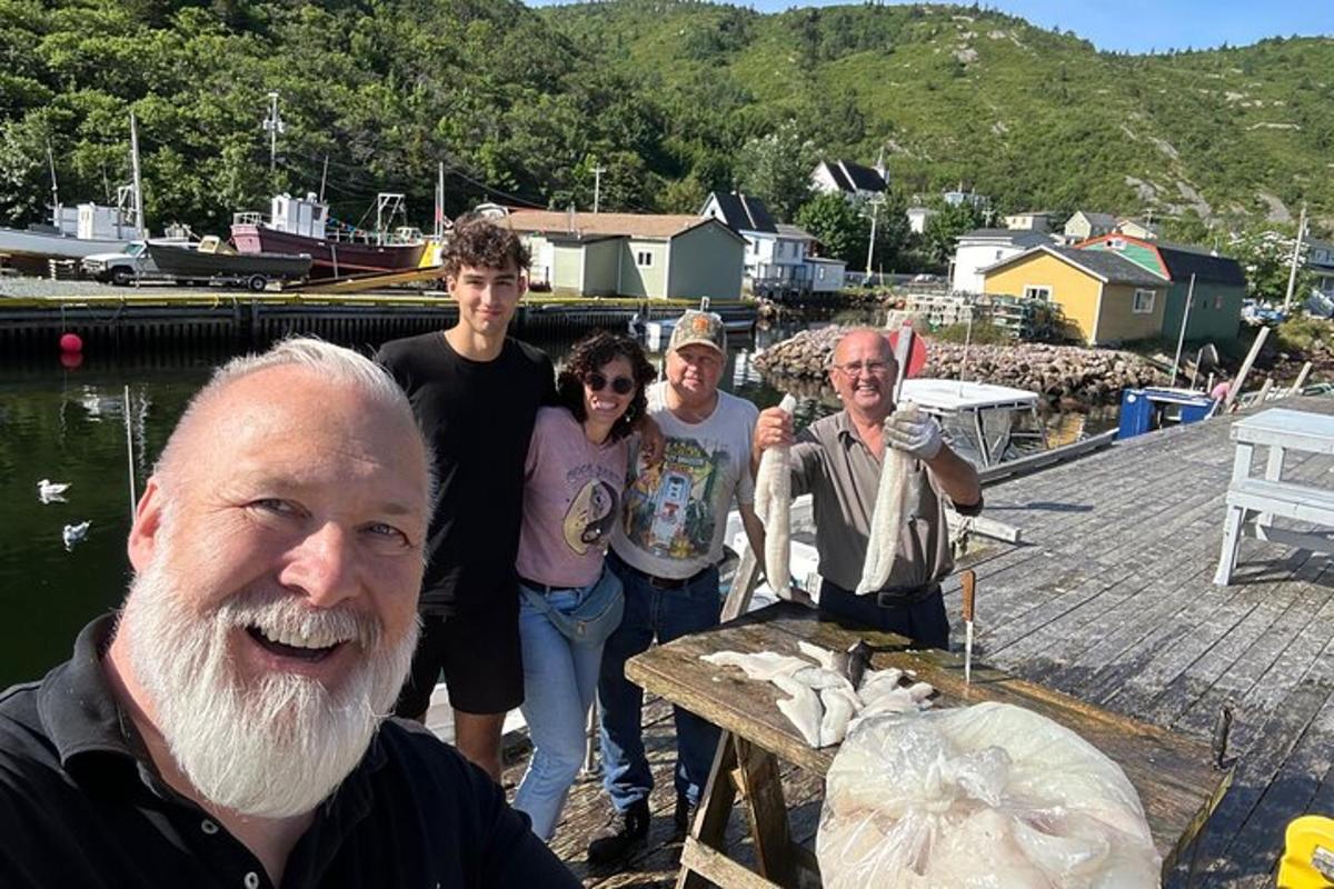 a group of people standing next to a body of water
