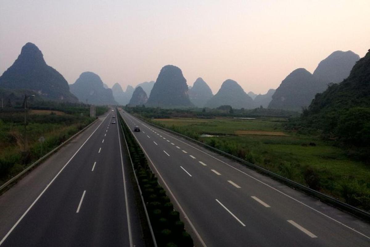 a highway in the li river with mountains in the background
