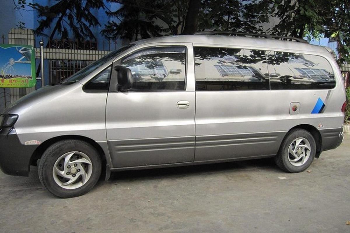 a silver van parked in a parking lot
