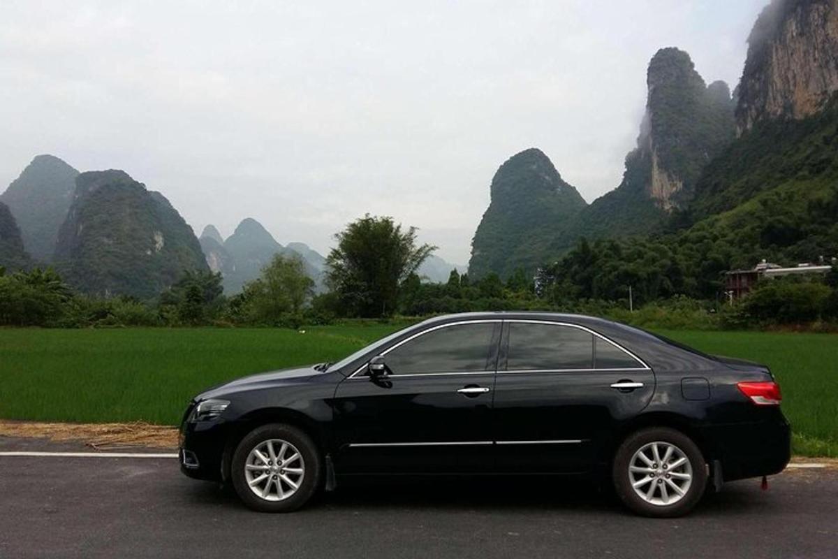 a black car parked on the side of a road