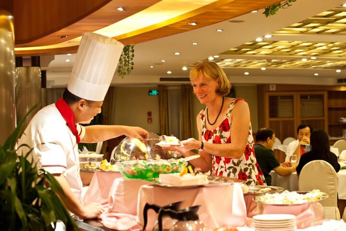 a man and a woman preparing food at a table