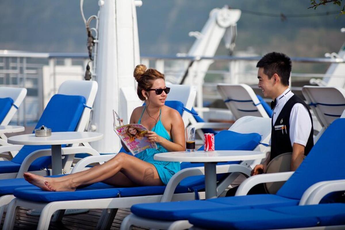 a man and a woman sitting at tables on a cruise ship
