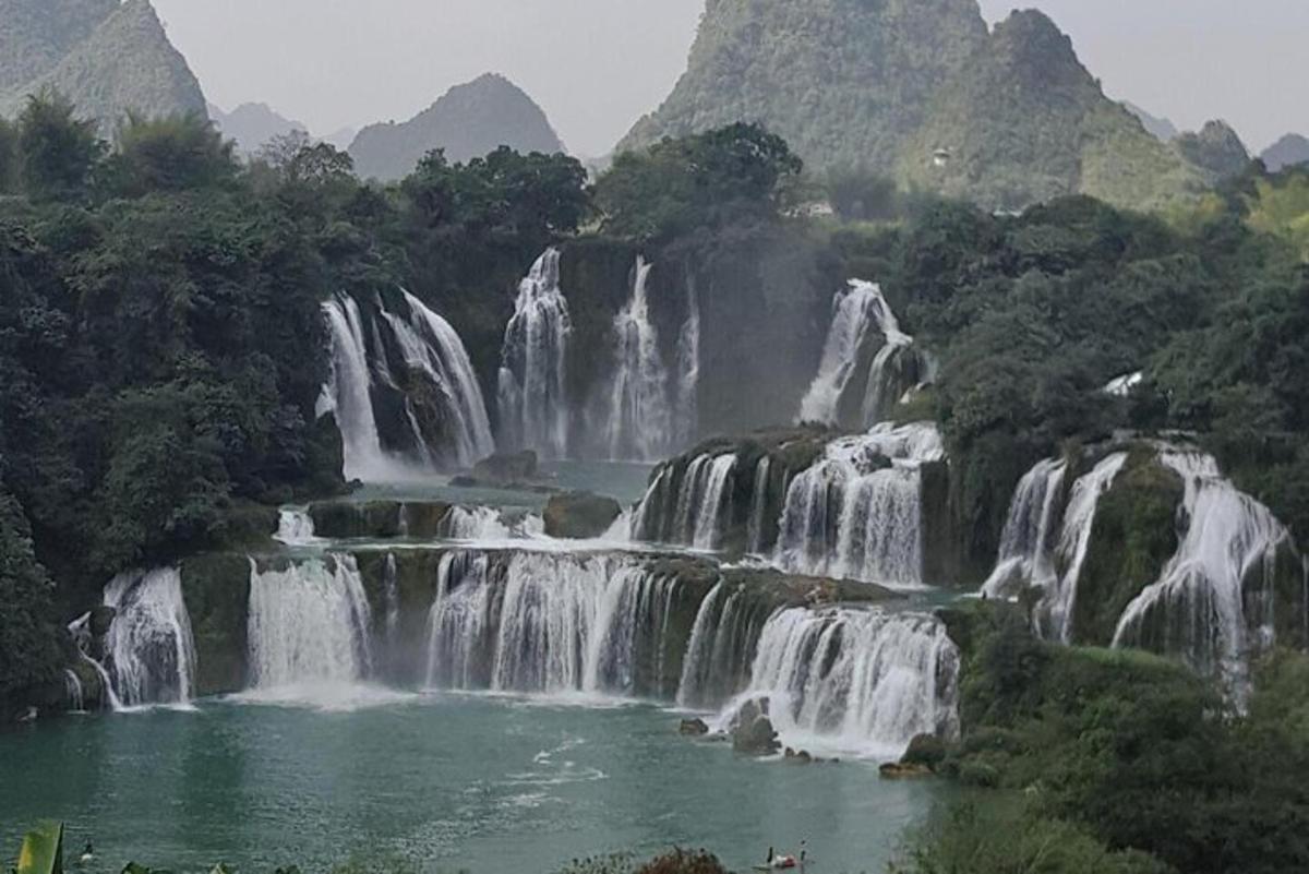 a group of waterfalls in a river with trees