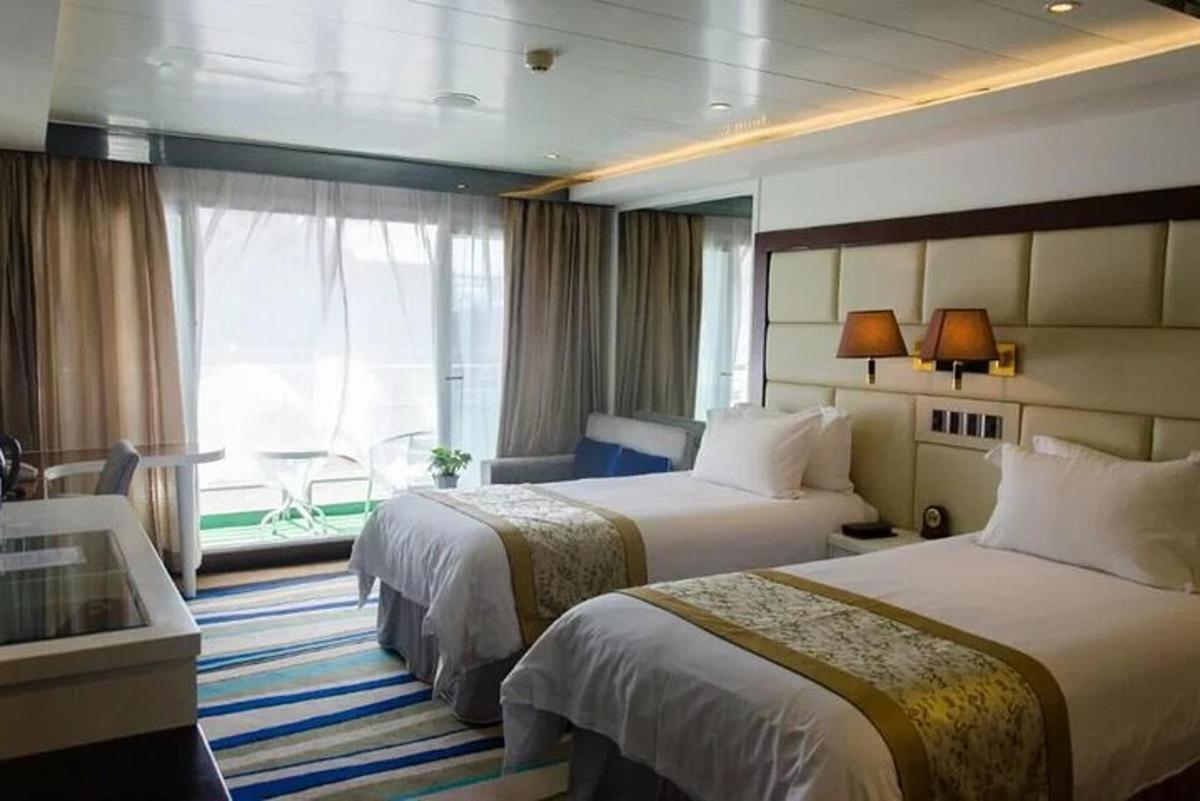 a hotel room with two beds and a window