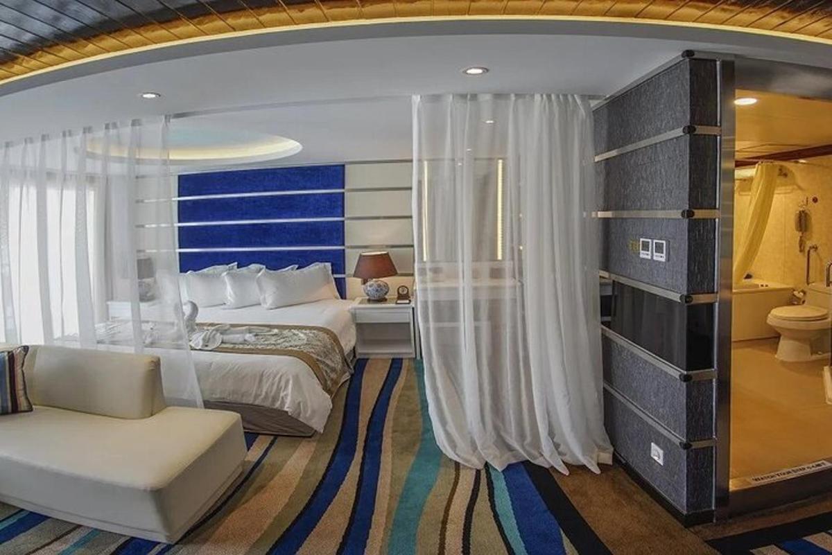 a bedroom with a bed and a couch and a chair