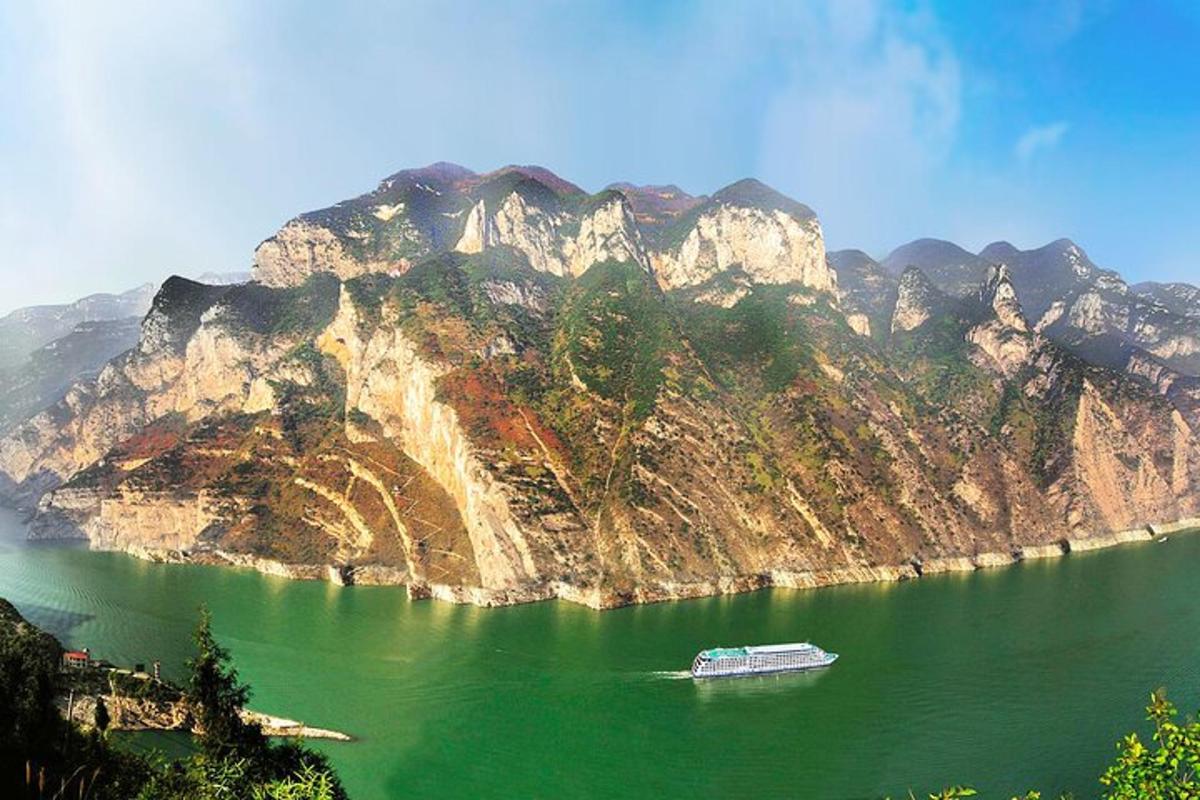 a boat on a lake in front of a mountain