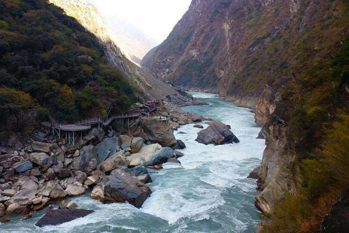 a river flowing through a canyon in a mountain
