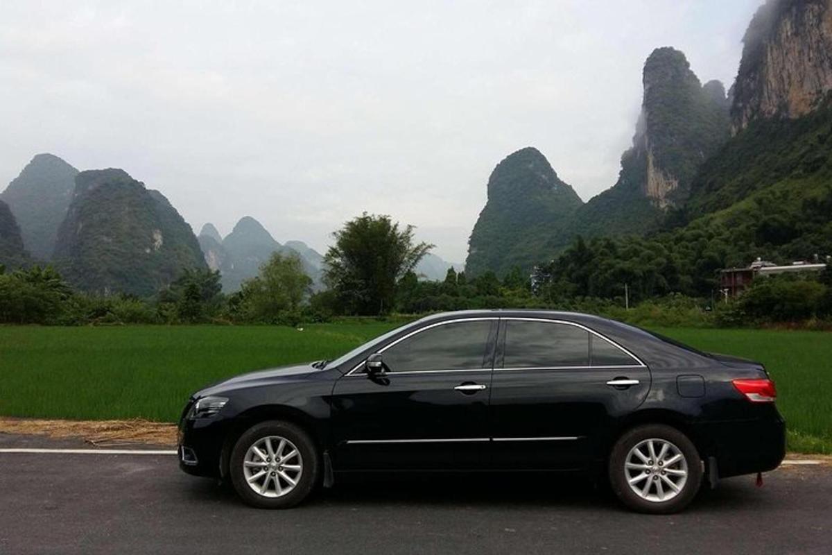 a black car parked on the side of a road