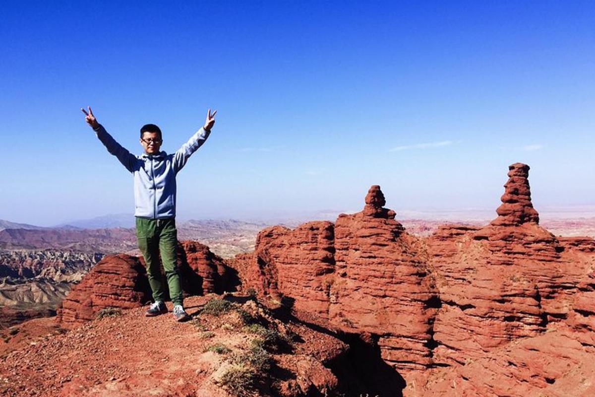 a man standing on the top of a mountain