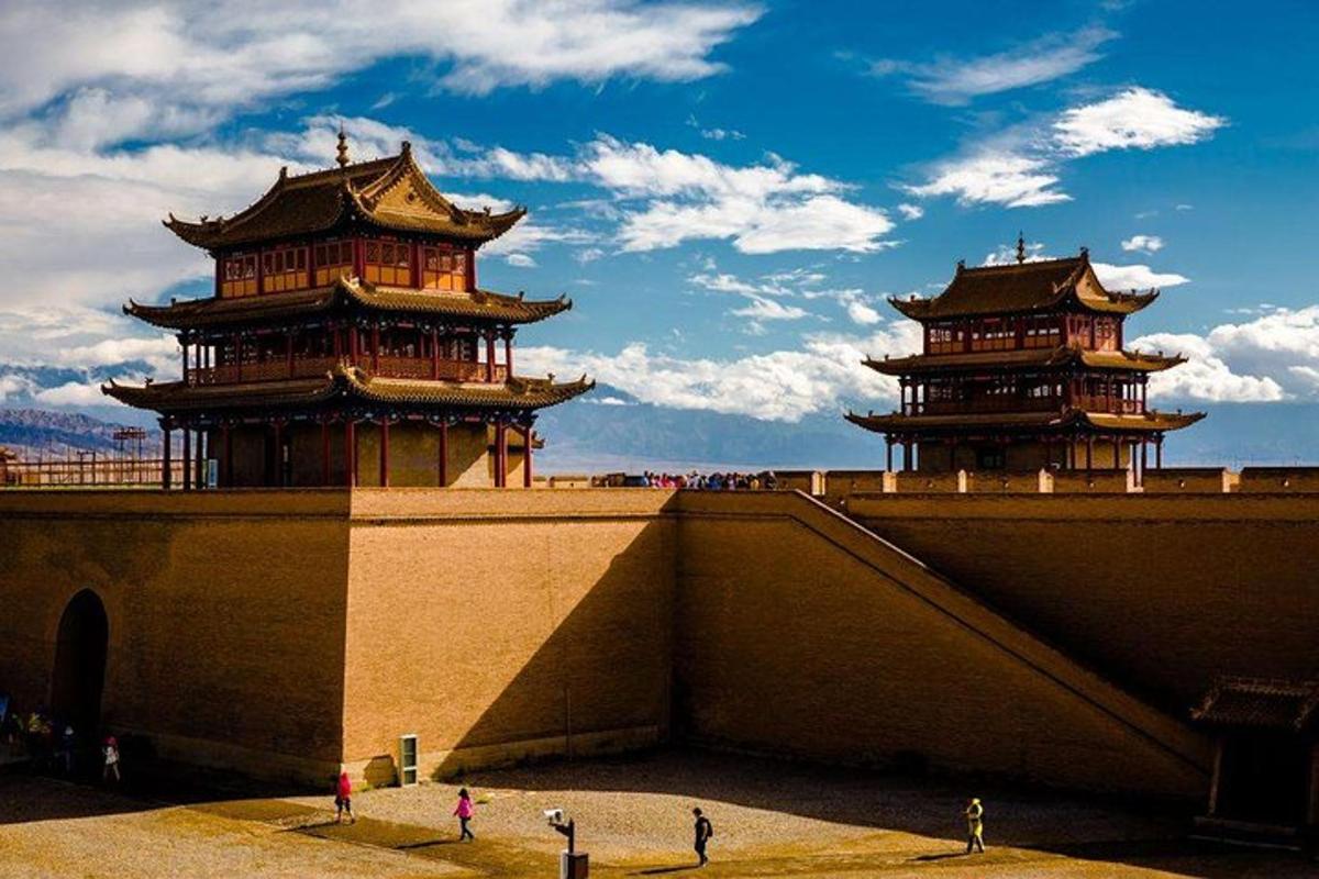 two towers on top of a building with people walking around