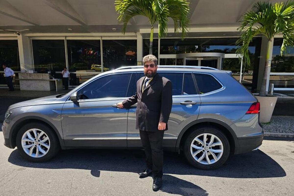 a man is standing in front of a car