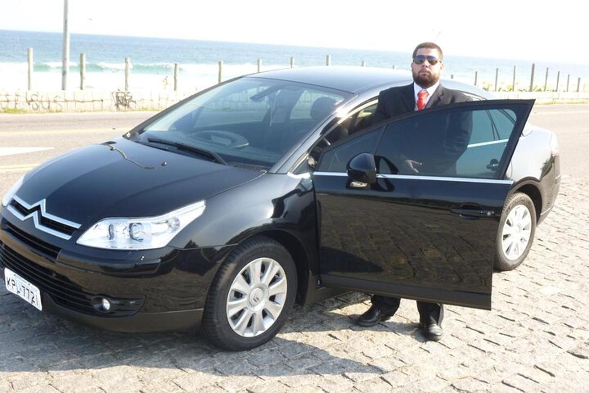 a man in a suit standing next to a car