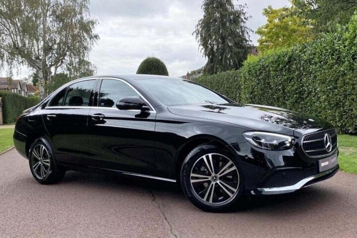 a black car is parked on a driveway