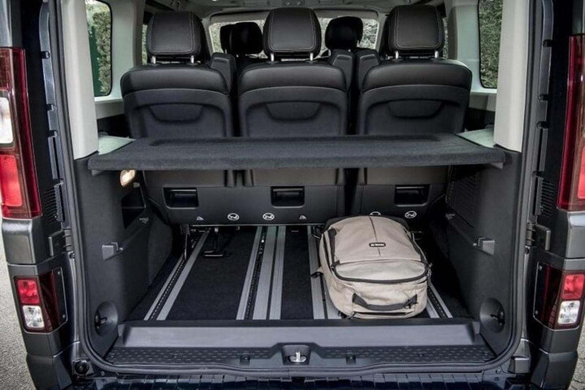 an open trunk of a van with a backpack in it