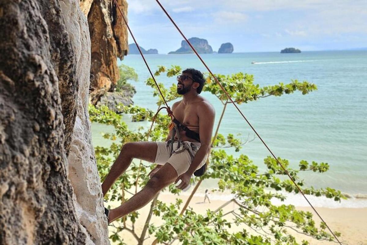 seorang lelaki di atas dinding batu di sebelah pantai