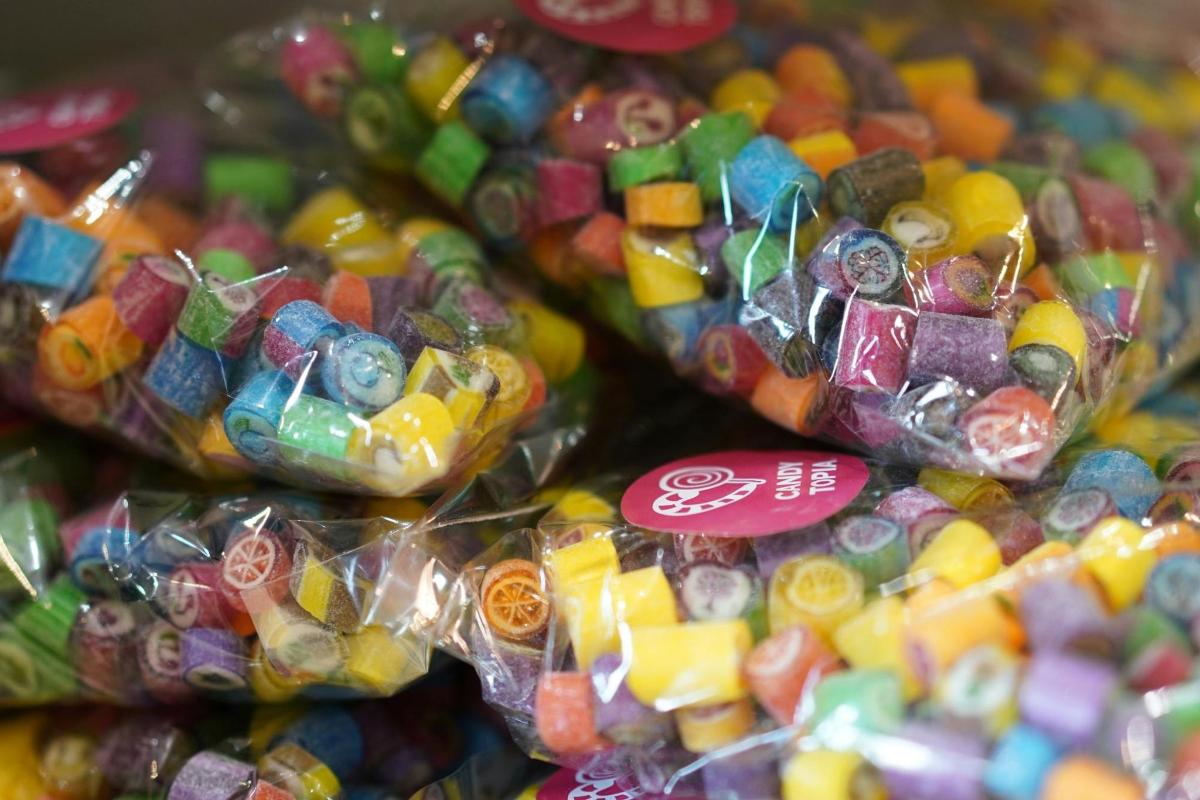 a pile of candy in plastic bags on display