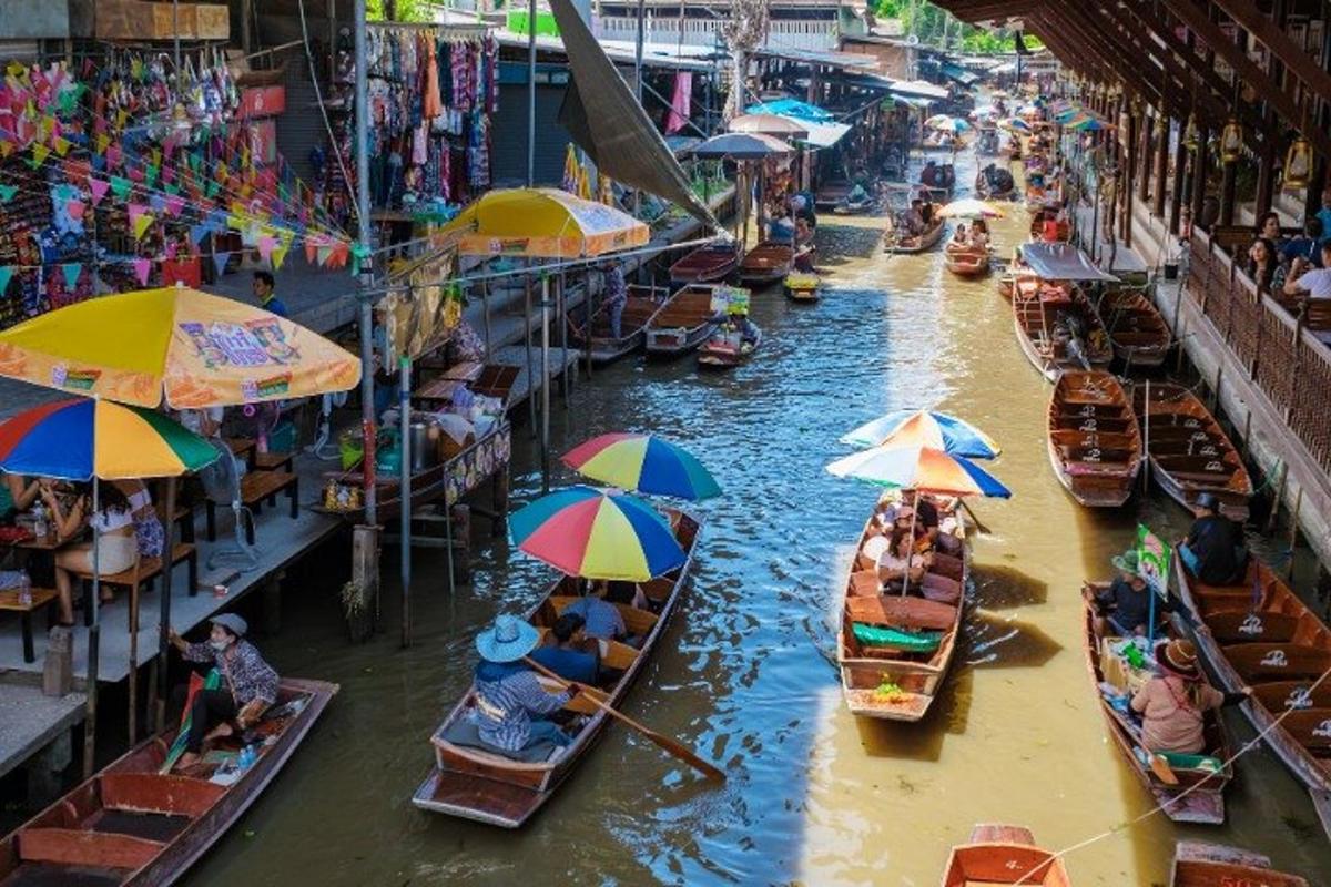 a group of boats in a river with umbrellas