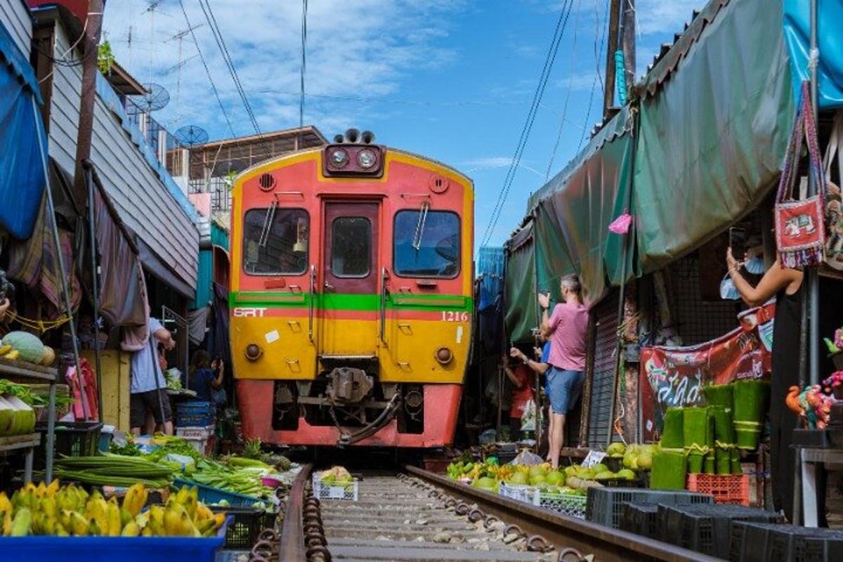 a train on the tracks at an outdoor market