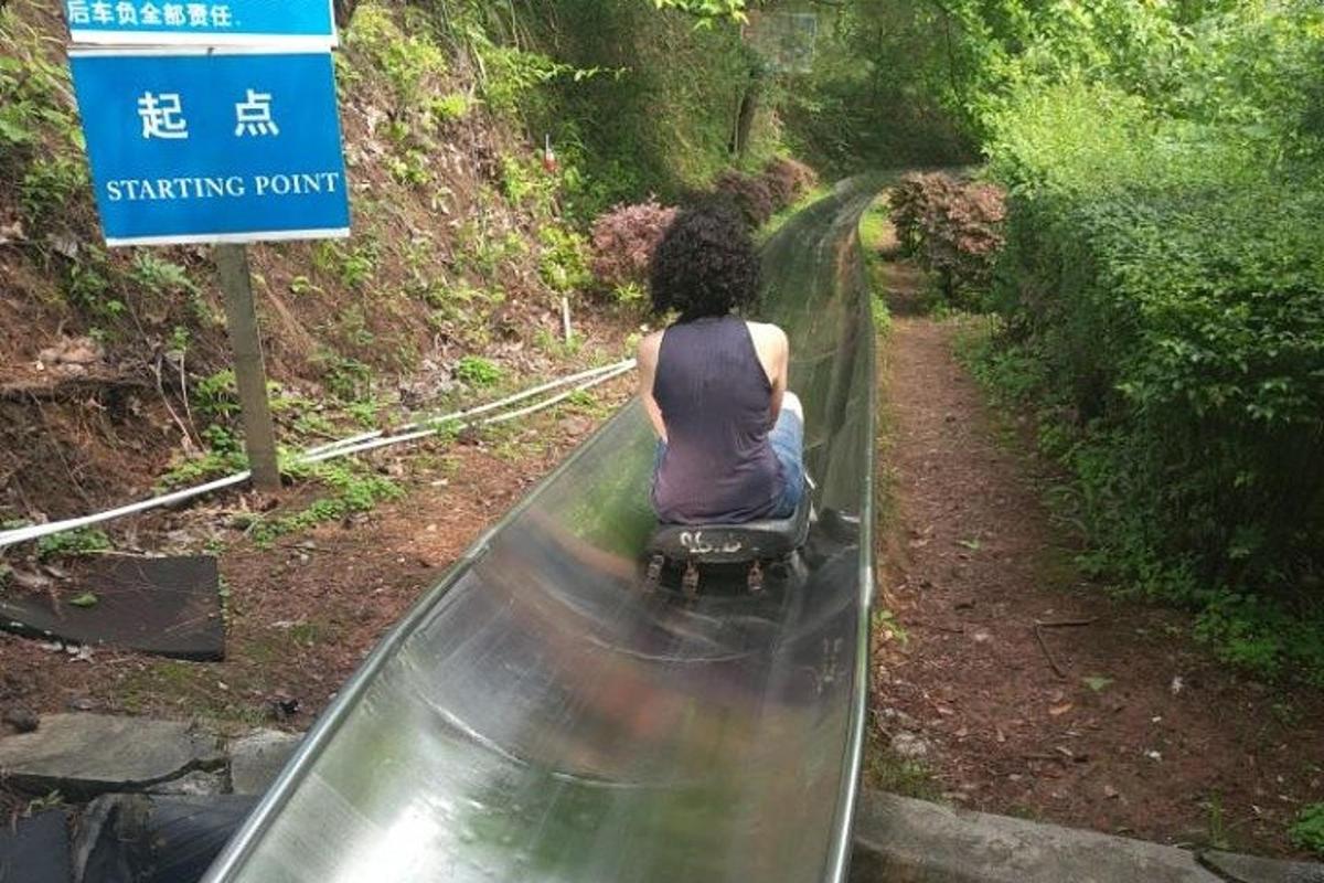 a woman is riding on a roller coaster