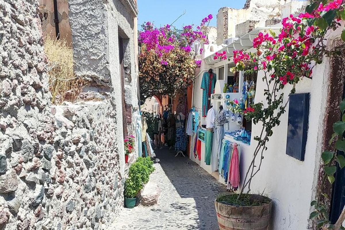 a narrow alley with clothes and flowers on a building