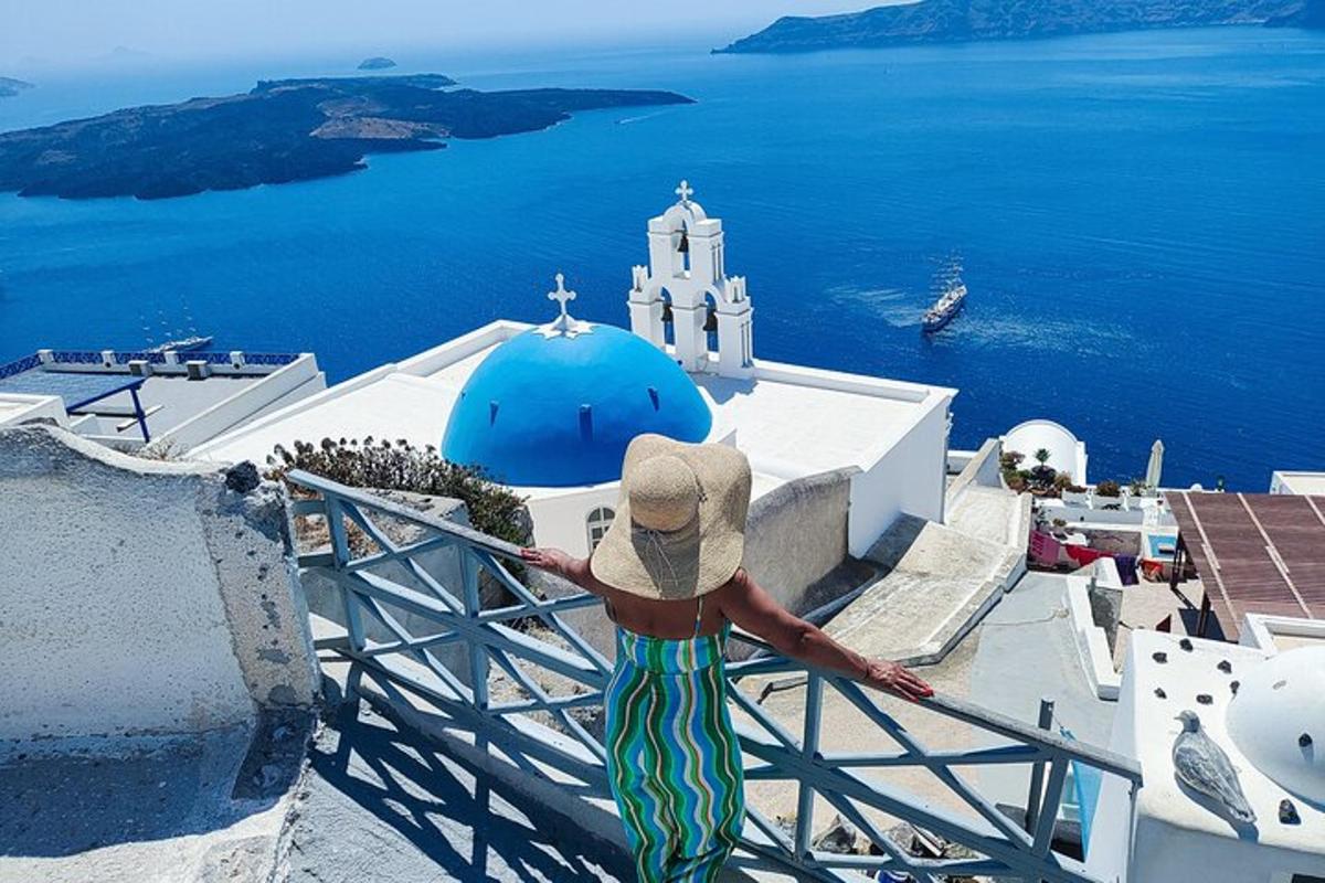 a woman in a hat standing on top of a building