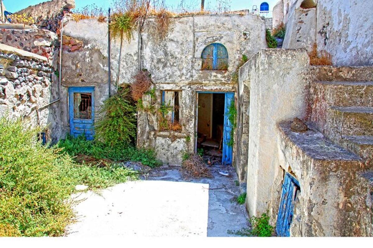 an old stone building with a door in a yard