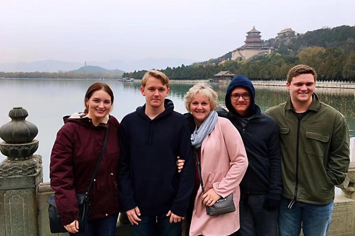 a group of people standing in front of a lake