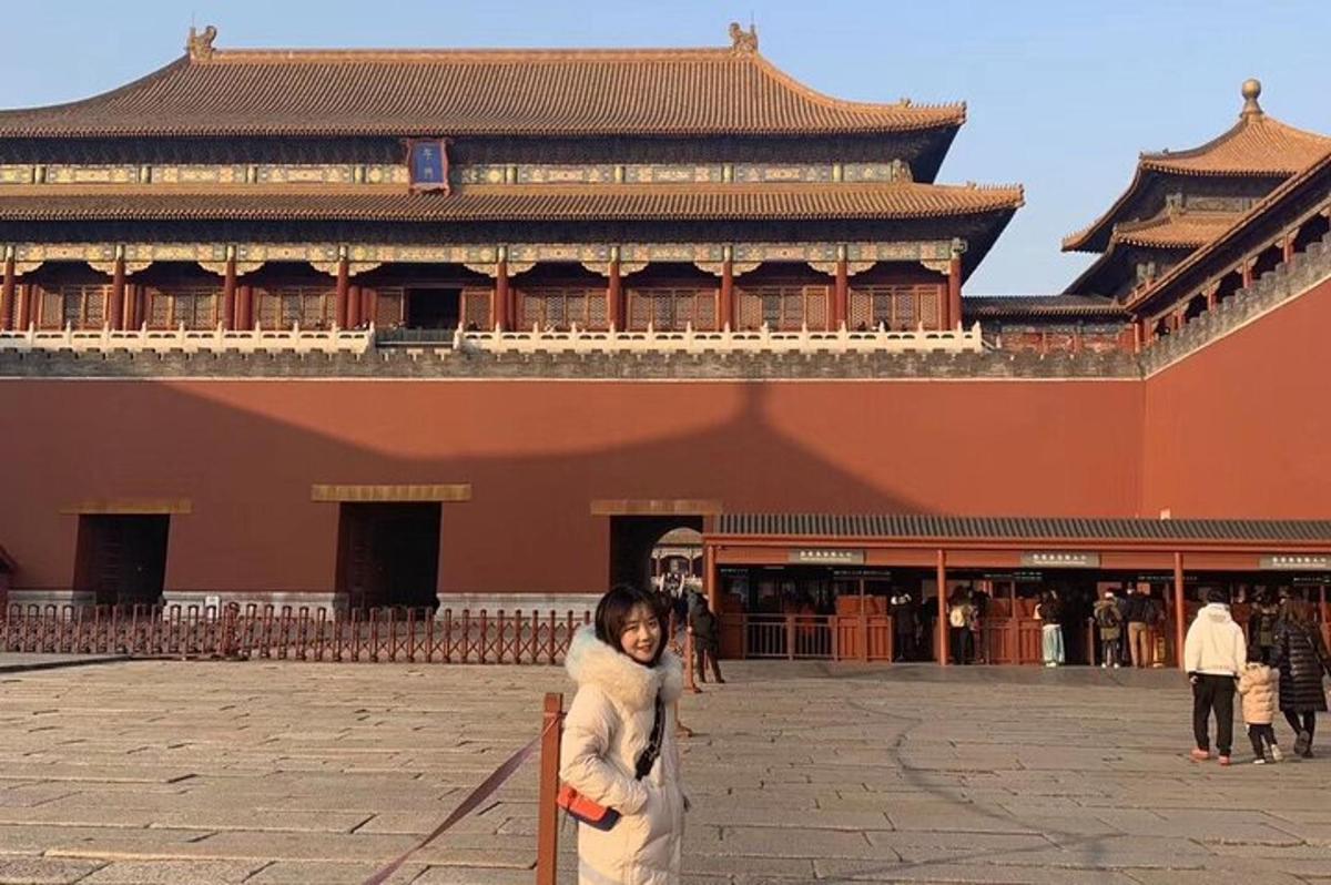 a woman standing on a pole in front of a building