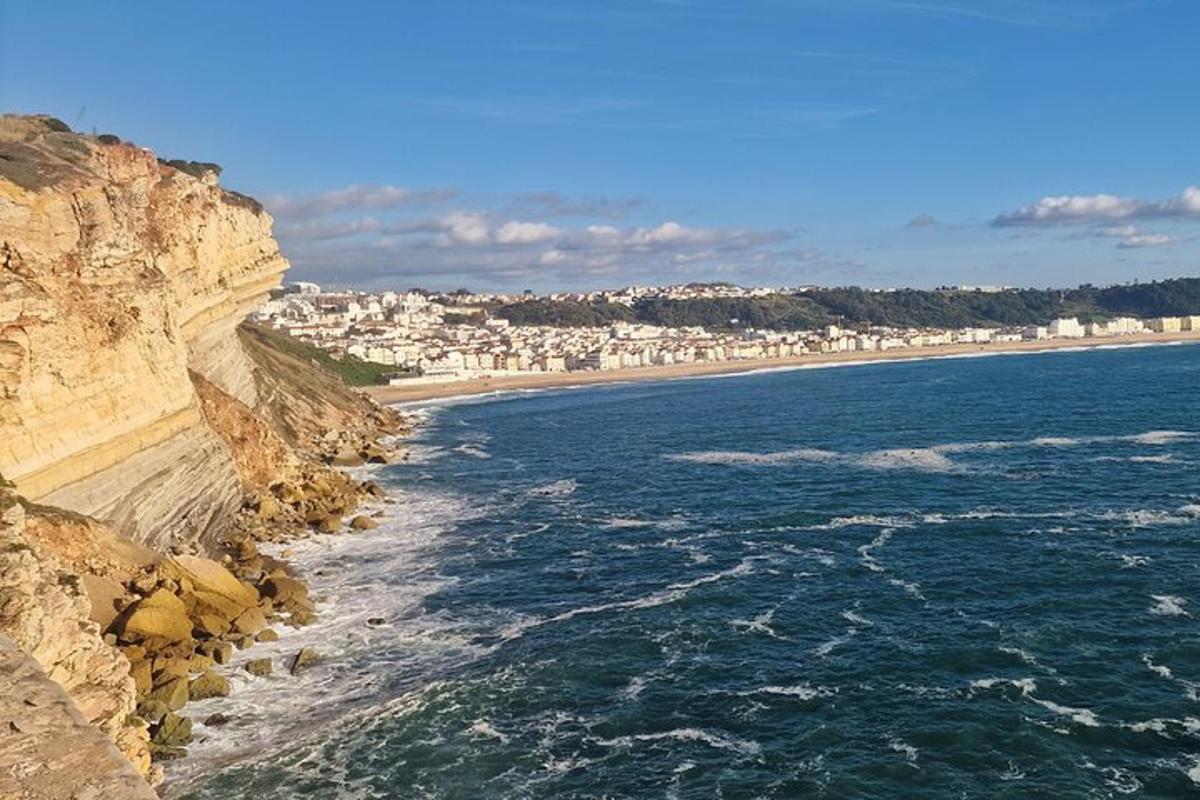 a view of the ocean and a beach with buildings