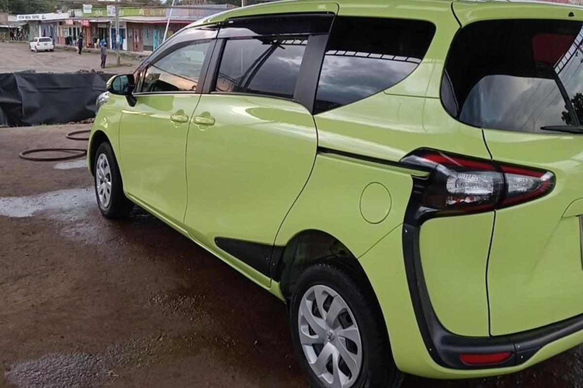 a green car parked in a parking lot