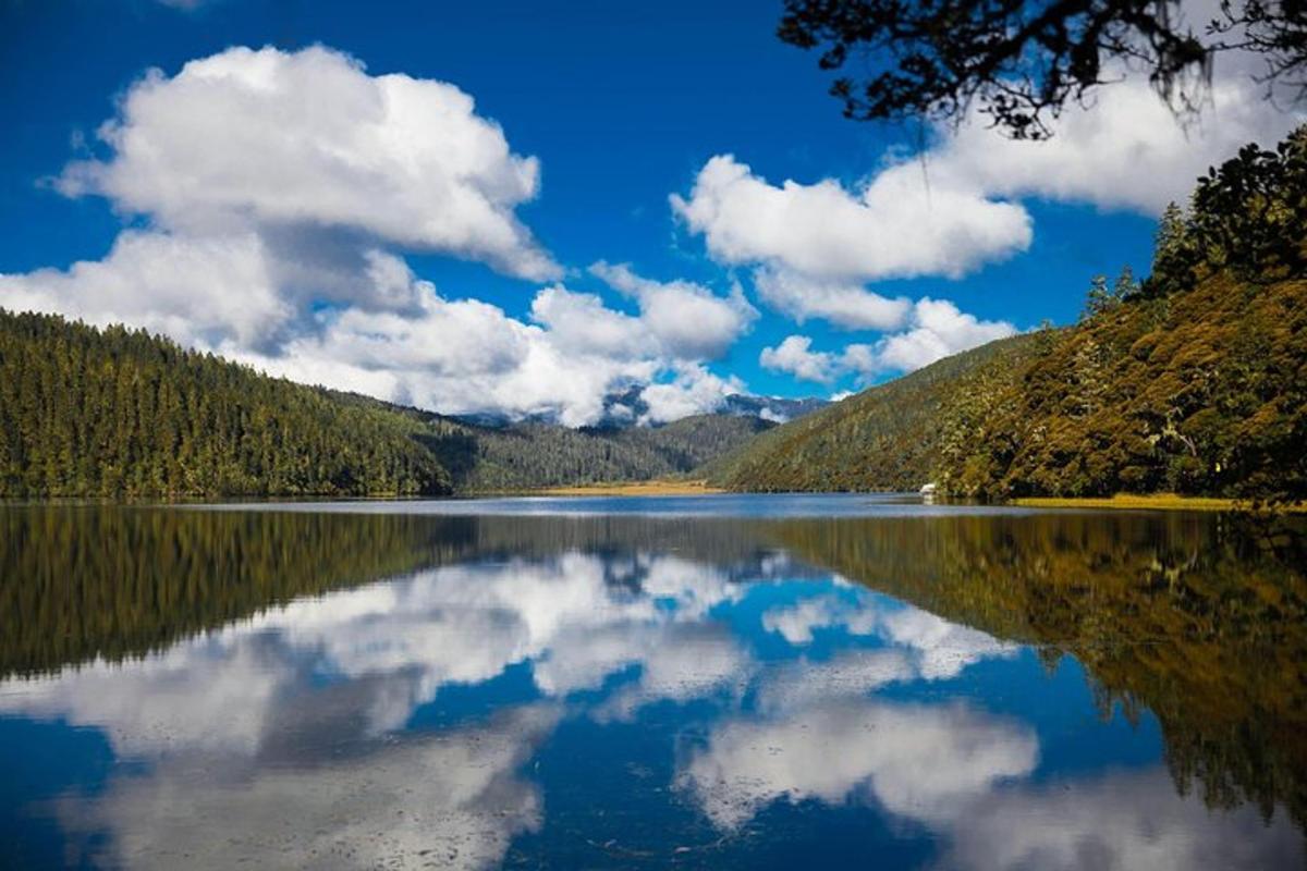 a lake with a reflection of the clouds in the water