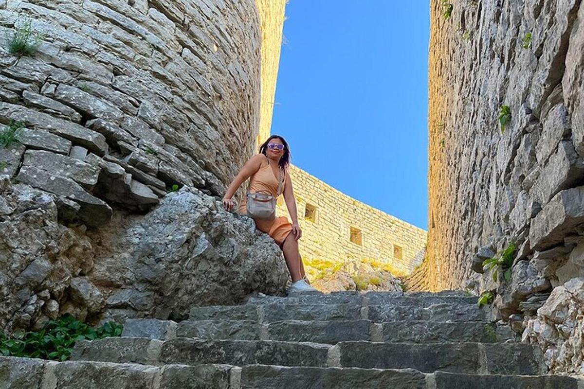 a woman is standing on some stairs