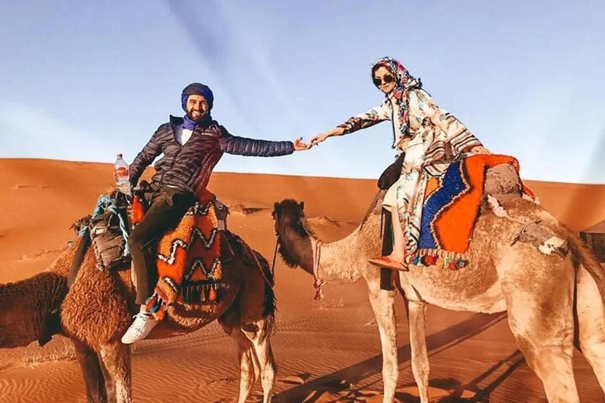 a man and a woman riding on camels in the desert