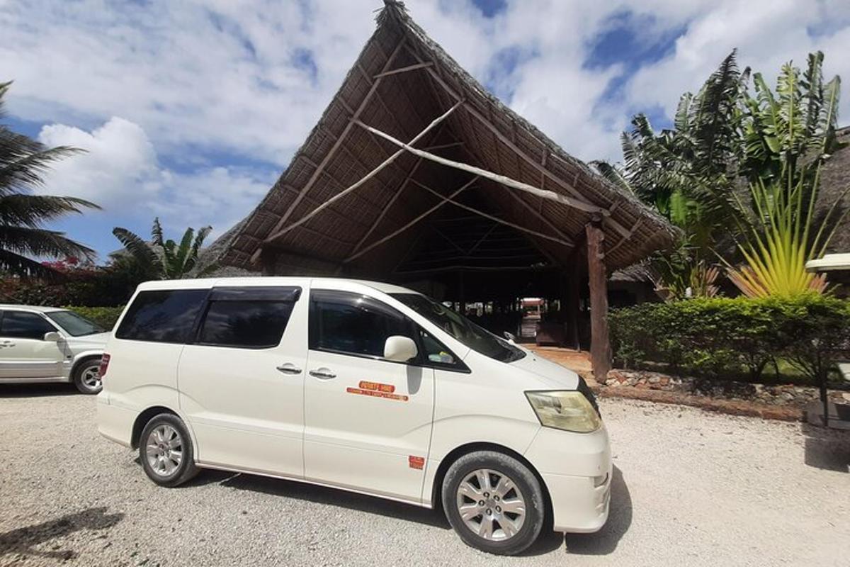 isang maliit na puting van ang pumarada sa harap ng isang gusali