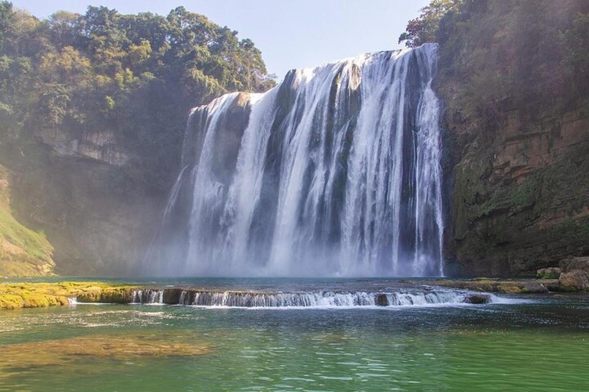 a waterfall with a pool of water in front of it