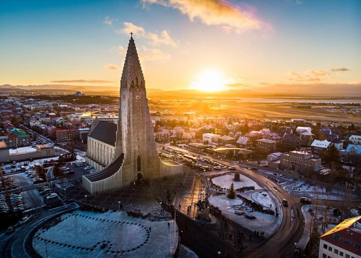 an aerial view of a city with a tower