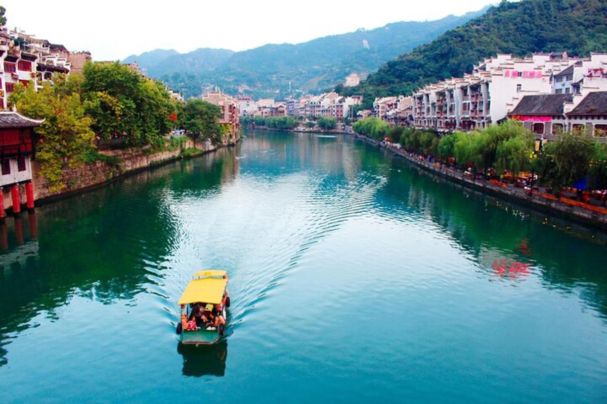 a boat traveling down a river in a city