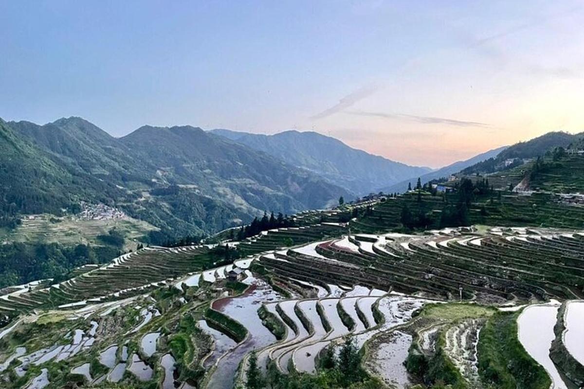 an aerial view of a mountain valley with terraced fields