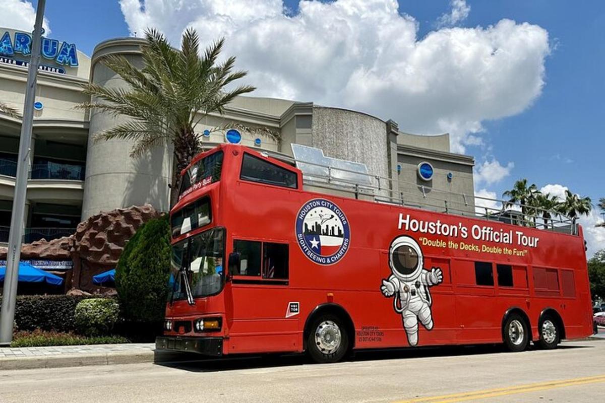 a red double decker bus parked in front of a building