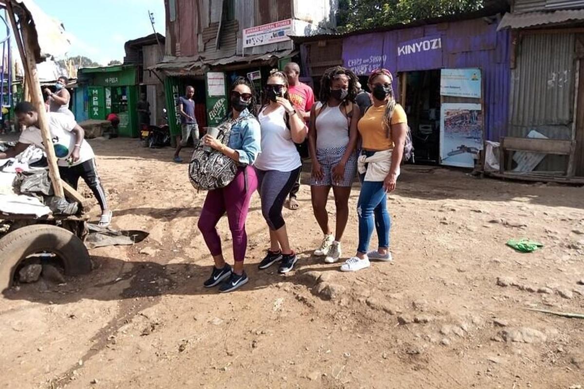 a group of people standing on a dirt road