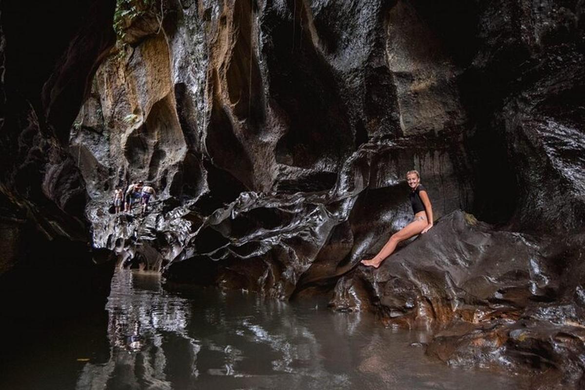 a woman sitting on a rock in the water