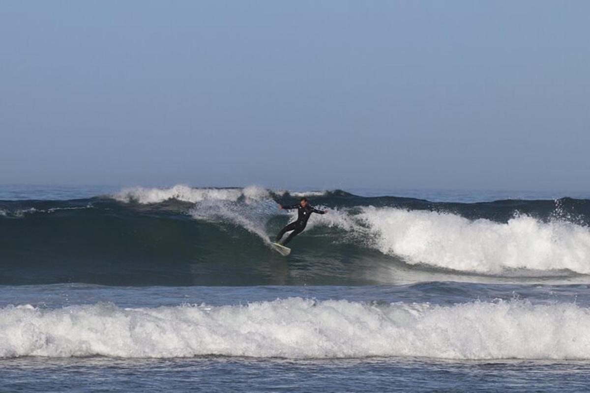 Un hombre montando una ola en una tabla de surf en el océano