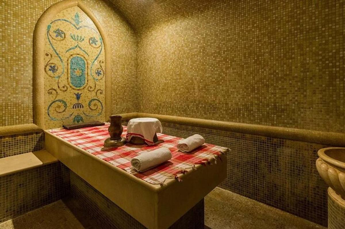 a bathroom with a tub and a toilet in it