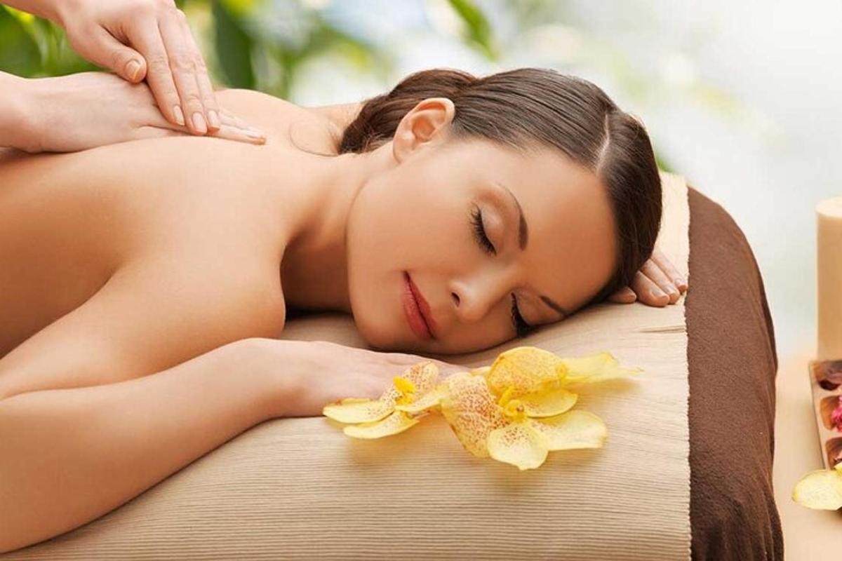 a woman getting a massage in a spa tub