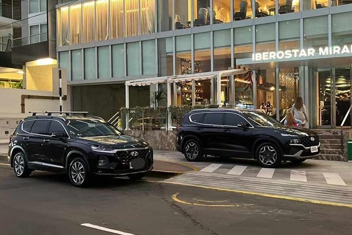 two black cars parked in front of a building