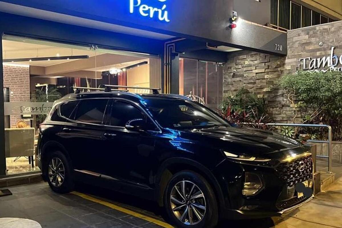 a black car parked in front of a store